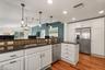 Kitchen sink, dishwasher, and side-by-side refrigerator