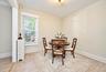 1st Floor: Neutral-toned walls, wood-finish flooring, a double-hung window, and a metal radiator enclosure