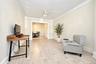 1st. Floor: Light-filled room featuring wood-finish flooring, crown molding, and a central ceiling fan with integrated lighting