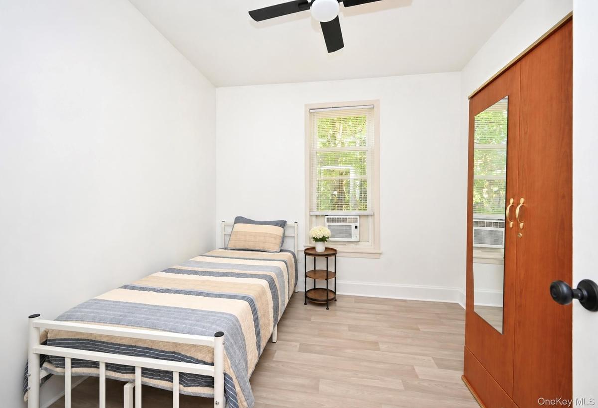 1st. Floor: Room featuring wood-finish flooring, ceiling fan, and window with natural exterior exposure