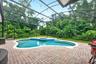 Private screeed pool and spa surrounded by beautiful mature trees.