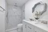Fully renovated bathroom with double sinks and rain shower head