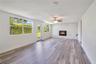 Family Room with wood-burning fireplace leading to backyard