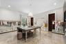 Recessed lighting, chandelier, wood-finish doors, window with plantation shutters, and polished stone flooring