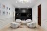 Recessed lighting with a modern chandelier, dark wood-finish built-in cabinetry, elegant wainscoting, and large format tile flooring