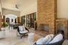 Stone-clad outdoor fireplace with integrated wood storage