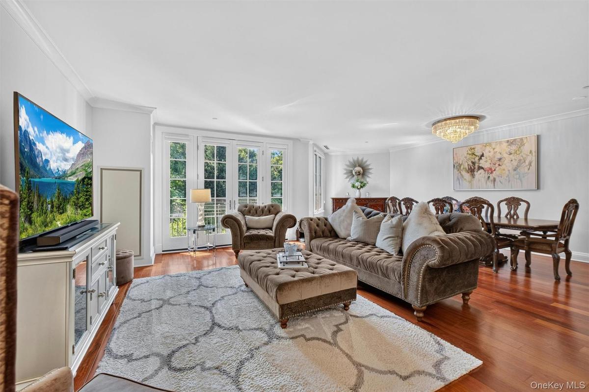 Living Room with Juliette doors allowing sunlight in.