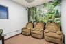 Room featuring a full-wall botanical mural, dropped ceiling, and a window with integrated blinds
