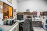 Built-in workstation featuring a wrap-around laminate desk surface, integrated drawer storage, and overhead wall-mounted shelving