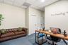 Interior space featuring neutral-toned walls, textured ceiling tiles, and blue carpeting