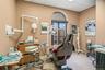 Arched window with decorative transom, drop ceiling, and solid-surface countertop with integrated basin