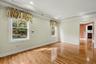 Primary bedroom featuring hardwood floors and large primary bathroom.