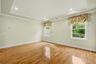Primary bedroom with tray ceiling and hi-hats.