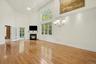 Sunfilled living/dining room anchored by a gas fireplace.