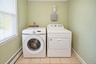 Laundry space featuring ceramic tile flooring, and dedicated hookups for washer and dryer.