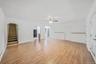 Open floor plan featuring laminate flooring, archway entrance leads to second floor.