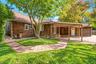Exterior featuring cedar shingle siding, covered patio, and paved walkway
