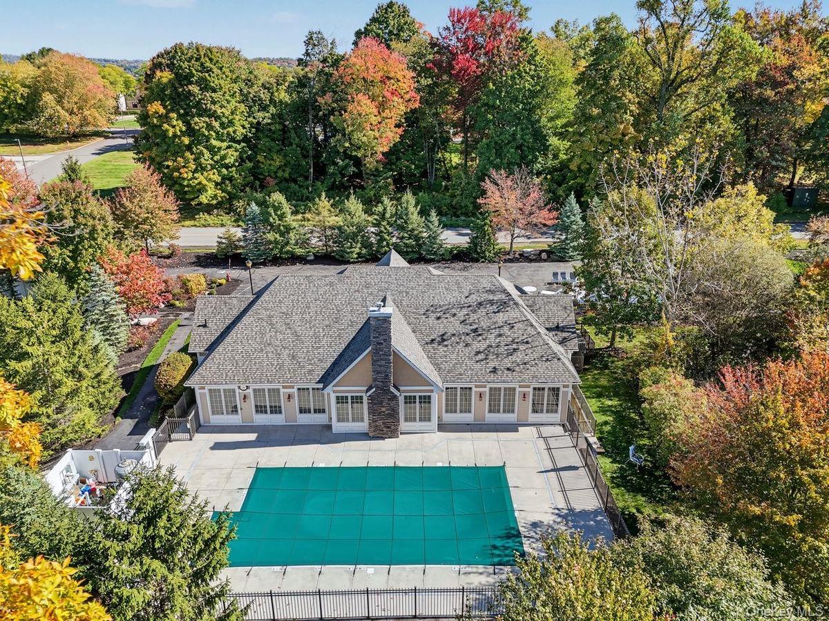 An active adult community with heated in-ground pool, club house with full kitchen, card room, fitness center, billards room, yoga room and hiking tra