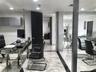 Polished stone flooring with decorative veining, recessed lighting, high-gloss wall-mounted cabinetry, and expansive glass partition wall