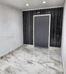 Large-format stone-patterned tile flooring, decorative vertical-striped wall paneling, and recessed ceiling lighting