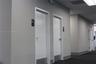 Commercial hallway featuring neutral-toned walls, recessed ceiling lighting, carpeting, and multiple interior doors with metal kick plates