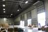 Industrial warehouse interior featuring high-clearance exposed ceilings, multiple grade-level overhead roll-up doors, and polished concrete flooring