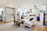 Spacious main living area with natural light, warm flooring, and an open-concept design.