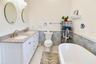 Spacious primary bathroom with double vanity, soaking tub, and beautifully coordinated finishes.