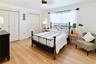 Comfortable downstairs bedroom with natural light and updated flooring.