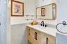 Stylish bathroom vanity with modern fixtures, attractive tilework, and generous counter space.