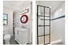 Updated downstairs bathroom with modern vanity and glass-enclosed shower.