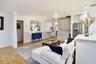 Expansive family room featuring a stone fireplace, built-in cabinetry, and generous seating space.