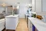 Updated kitchen featuring quartz countertops, stainless steel appliances, and a spacious center island.