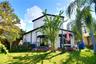 Private fenced backyard with mature landscaping and space for outdoor enjoyment.