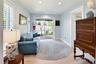 Charming sitting room with sliding glass doors opening to the backyard.