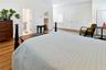 Another perspective of the primary bedroom, showcasing its flexible layout and generous space.