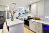Generous kitchen workspace with custom cabinetry, modern finishes, and a functional island.