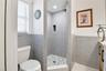 Tastefully updated bathroom with tiled walk-in shower and contemporary finishes.