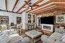 Natural light pours into the spacious family room that features warm brick walls, exposed wood beams and distinctive diamond-pane windows that create 