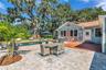The enormous fully fenced backyard is designed for year-round enjoyment with a gas-heated saltwater sport pool, outdoor kitchen, expansive brick paved