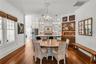 The Formal Dining room offers a seamless connection to the kitchen while maintaining its own distinct character. A custom built-in beverage bar serves