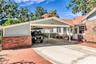 Double Carport includes both a Tesla and golf cart charging station as well as a large storage closet equipped with power and a shop desk.
