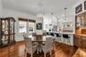 The Formal Dining room offers a seamless connection to the kitchen while maintaining its own distinct character. A custom built-in beverage bar serves