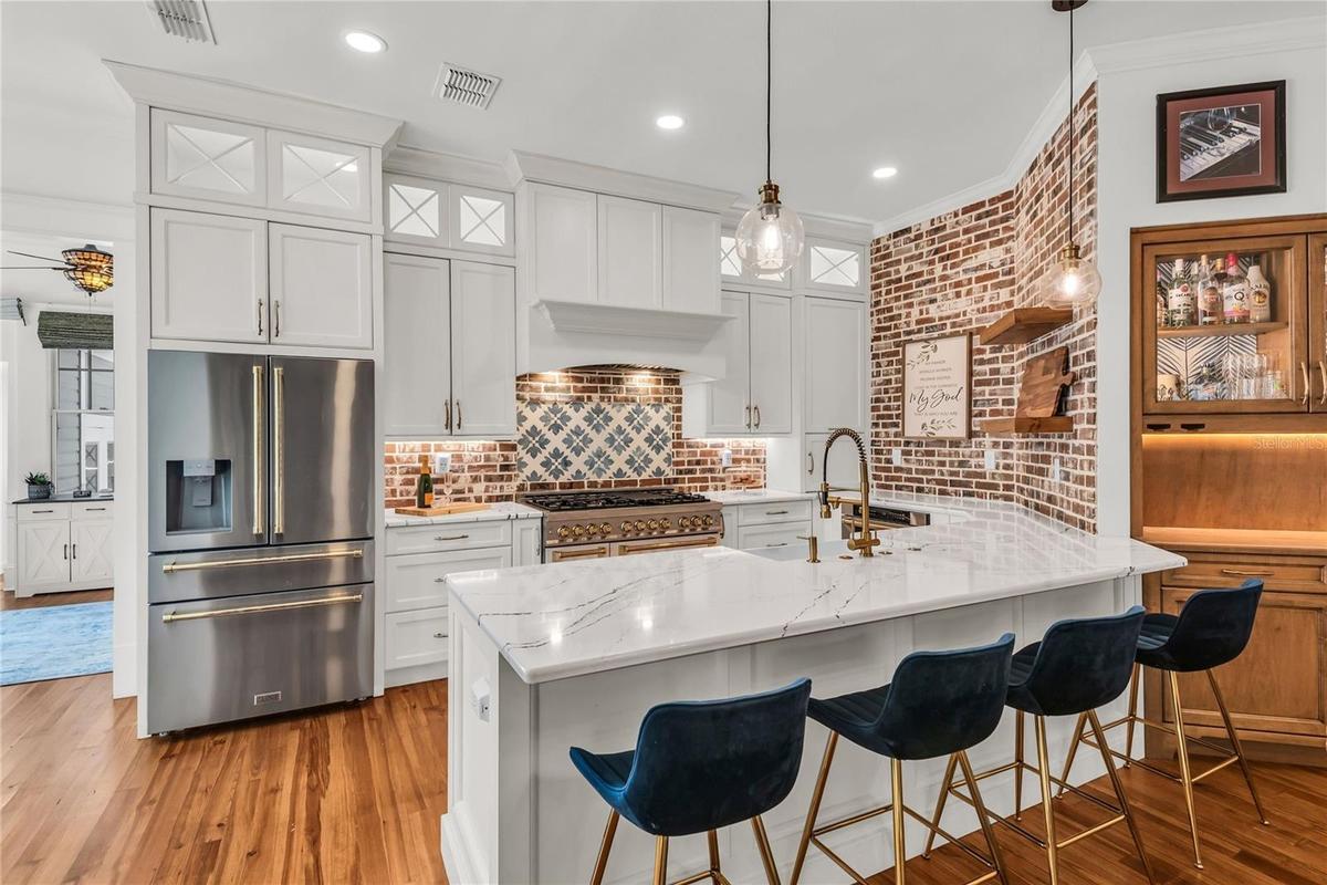 The chef's kitchen is a true focal point with a distinctive mix of old-world charm and modern design that combine luxury and function