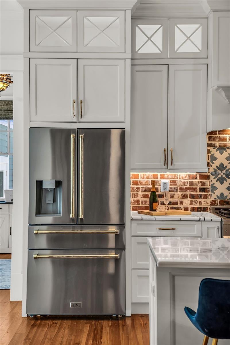The chef's kitchen is a true focal point with a distinctive mix of old-world charm and modern design that combine luxury and function