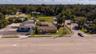 Aerial of front of building facing major thoroughfare 15-A. Building and vacant lot zoned B4.