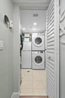 Laundry room with extra refrigerator.