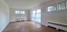 Living room has hardwood flooring and picture window