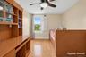 Wood-finish flooring, ceiling fan with integrated lighting, and a window