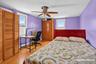Wood-finish flooring, ceiling fan, and multiple windows